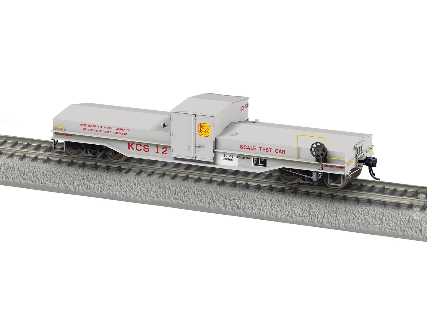 Model train car on a track with 'KCS 12' and 'Scale Test Car' text.