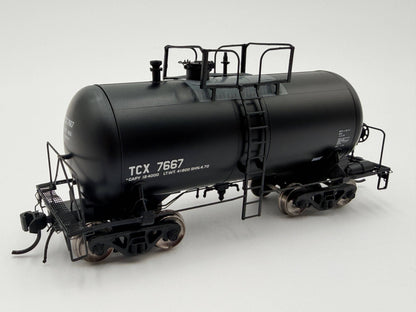 Model of a black tanker train car with 'TCX 7667' on a white background