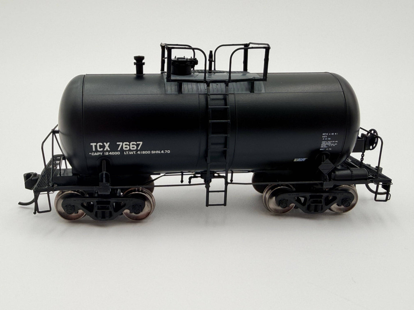 Model of a black tanker train car with 'TCX 7667' on a white background