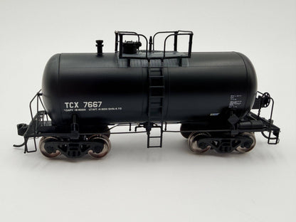 Model of a black tanker train car with 'TCX 7667' on a white background